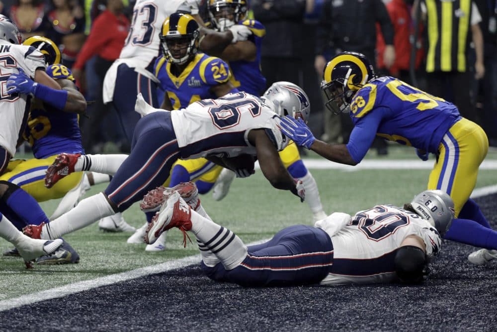 New England Patriots' Sony Michel (26) dives over the goal line for a touchdown in front of Los Angeles Rams' Cory Littleton (58) during the second half of the NFL Super Bowl 53 football game Sunday, Feb. 3, 2019, in Atlanta. (AP Photo/David J. Phillip)