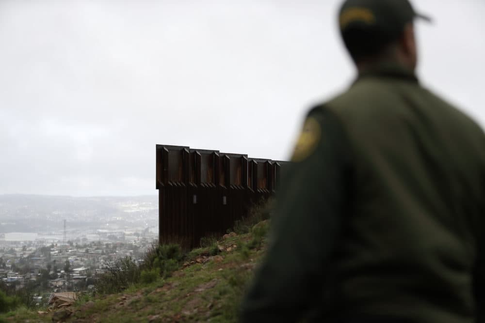 Border Patrol agent Vincent Pirro stands near where the border wall ends that separates Tijuana, Mexico, left, from San Diego, Tuesday, Feb. 5, 2019, in San Diego. (Gregory Bull/AP)