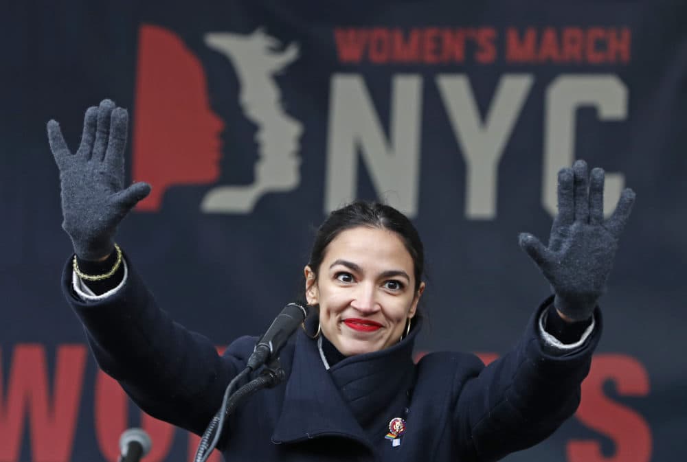 In this Jan. 19, 2019 photo, U.S. Rep. Alexandria Ocasio-Cortez, (D-New York) waves to the crowd after speaking at Women's Unity Rally in Lower Manhattan in New York. Democrats including Ocasio-Cortez of New York and veteran Sen. Ed Markey of Mass. are calling for a Green New Deal intended to transform the U.S. economy to combat climate change and create jobs in renewable energy. (Kathy Willens/AP)