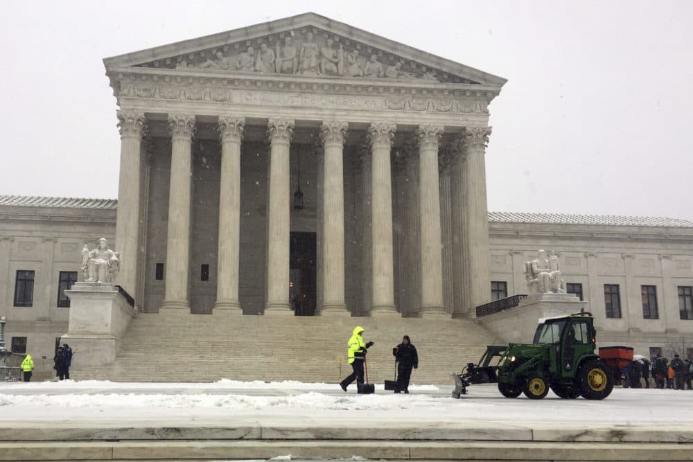 Crews remove snow at the U.S. Supreme Court Wednesday, the day the court released its decision limiting civil asset forfeiture. (Jessica Gresko/AP)