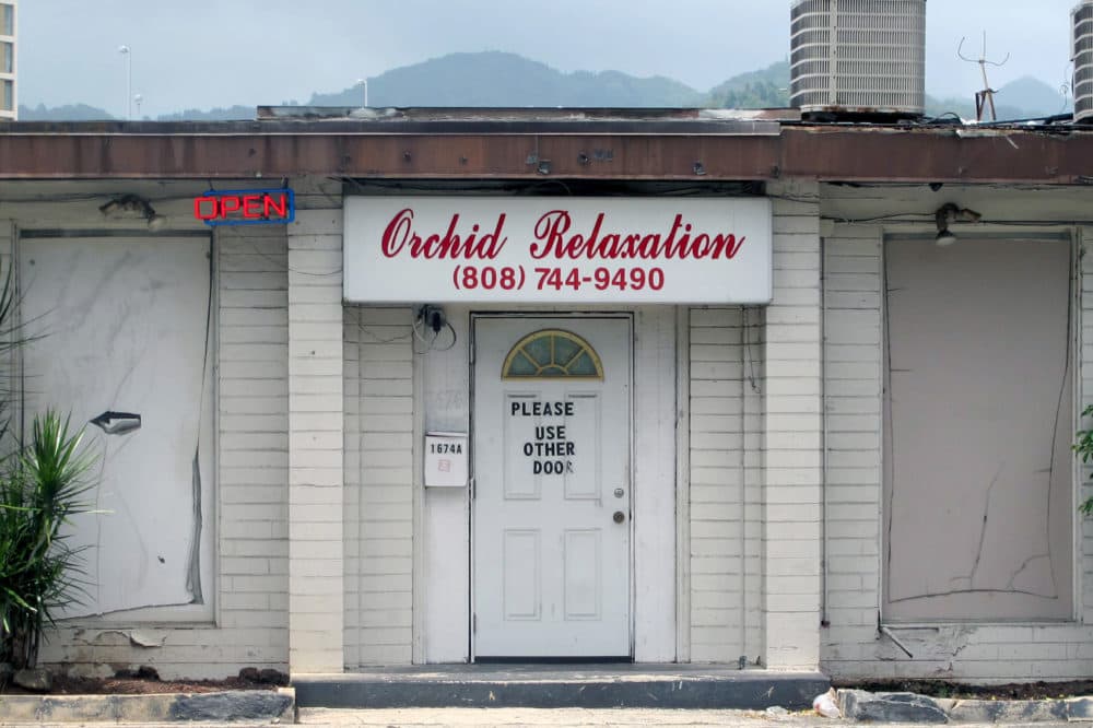 An open sign hanging outside Orchid Relaxation in Honolulu, May 6, 2015. The massage parlor was one of several local businesses that were targeted in a police prostitution sting. (Jennifer Sinco Kelleher,File/AP)