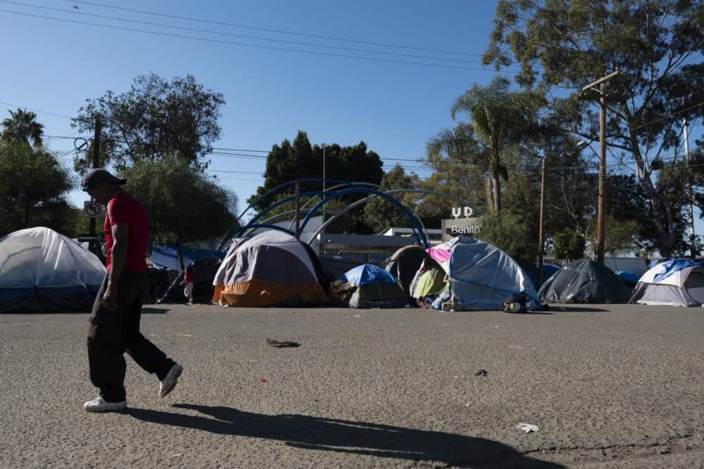 A man walks by an encampment of tents in Tijuana, Mexico where some refugees were living outside the Benito Juarez Soccer Stadium. (Courtesy Jozef Staska)