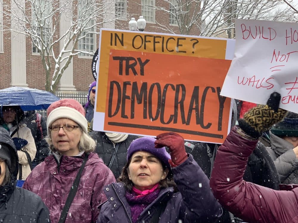 More than 100 people protested at a &quot;Presidents Day Protest to Fight Trump's fake Crisis and Racist Deportation Forces,&quot; on Monday, Feb. 18, 2019. (Simón Rios/WBUR)