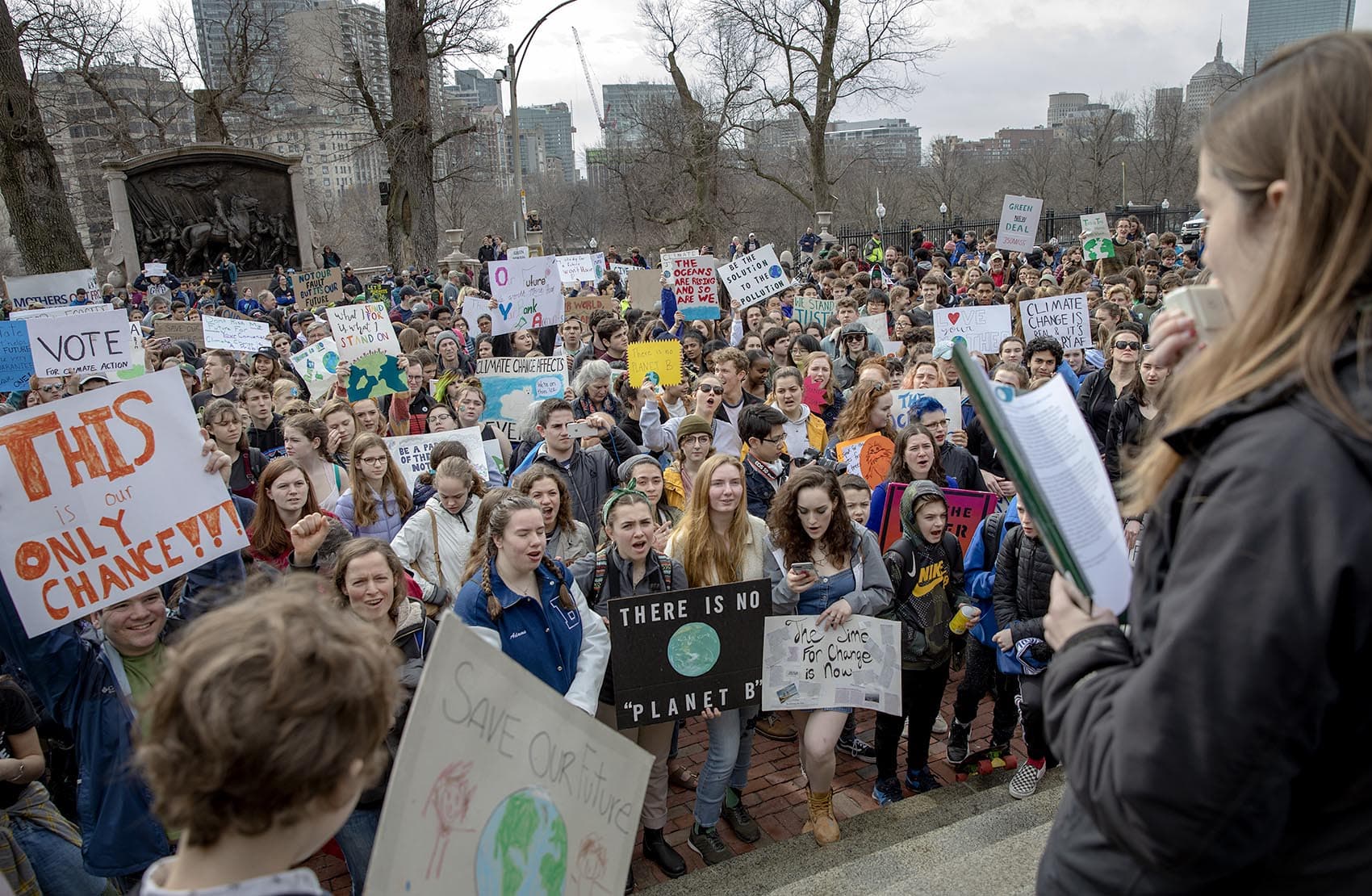 Students and supporters of the Massachusetts Youth Climate Strike crowd around the steps of the State House. (Robin Lubbock/WBUR)