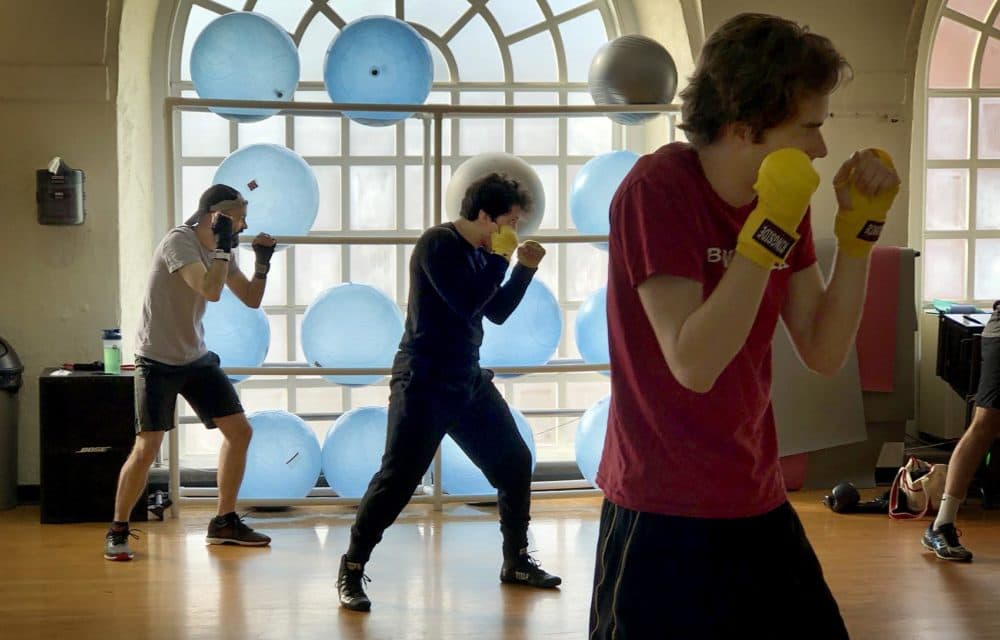 Harvard junior José Larios (center) during a workout with the boxing club. (Max Larkin/WBUR)