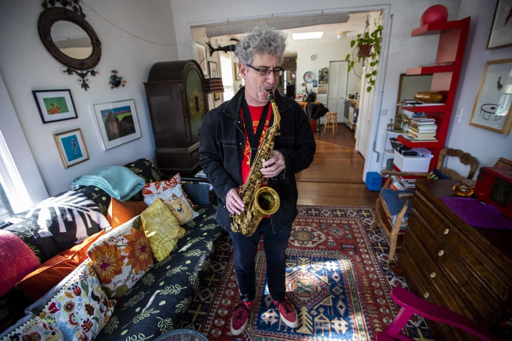 Musician and composer Ken Field playing saxophone at his apartment in Cambridge. (Jesse Costa/WBUR)