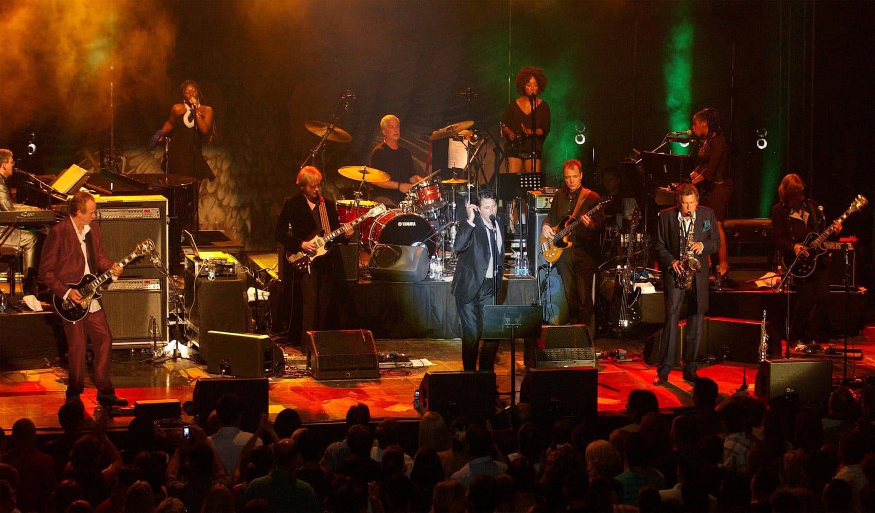 Brian Ferry, center, performs during a concert of the British pop band Roxy Music in Macedonia's southwestern town of Ohrid on July 14, 2006. (Boris Grdanoski/AP)