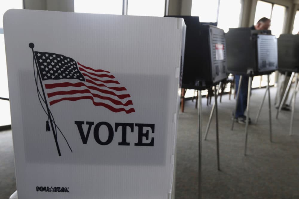 Voters cast their ballots in the Illinois primary in Hinsdale, Ill, March 18, 2014. (M. Spencer Green, File/AP)