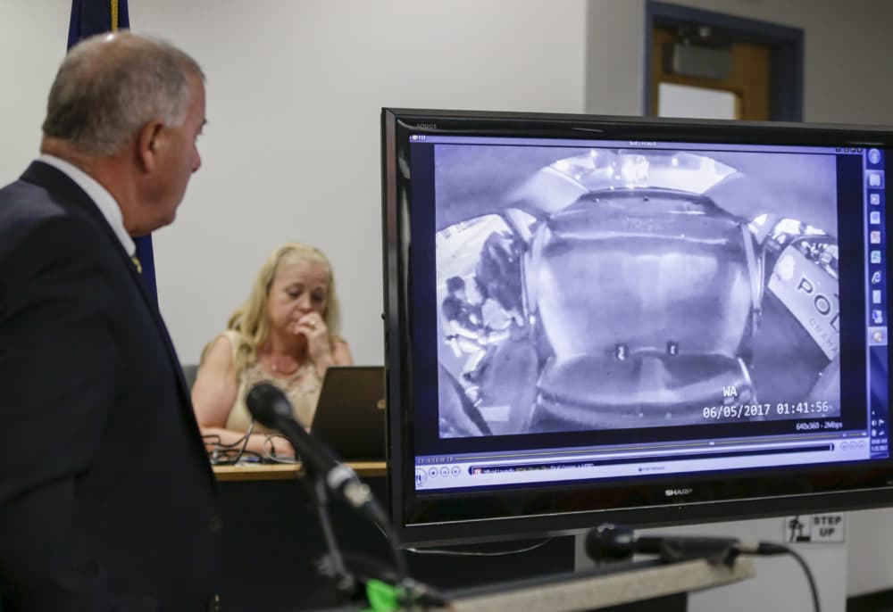 Douglas County Attorney Don Kleine , left, watches a June 5, 2017 police video showing the arrest of 29-year-old Zachary Bearheels, a mentally ill Oklahoma man, Wednesday, July 26, 2017 in Omaha, Neb. (Nati Harnik/AP)