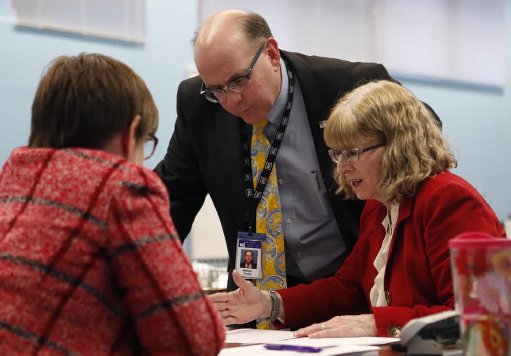 Maine Secretary of State Matthew Dunlap works with Deputy Secretary of State Julie Flynn, right, during the ballot-tabulation process for Maine's Second Congressional District's House election, Tuesday, Nov. 13, 2018, in Augusta, Maine. The election is the first congressional race in American history to be decided by the ranked-choice voting method that allows second choices. (Robert F. Bukaty/AP)