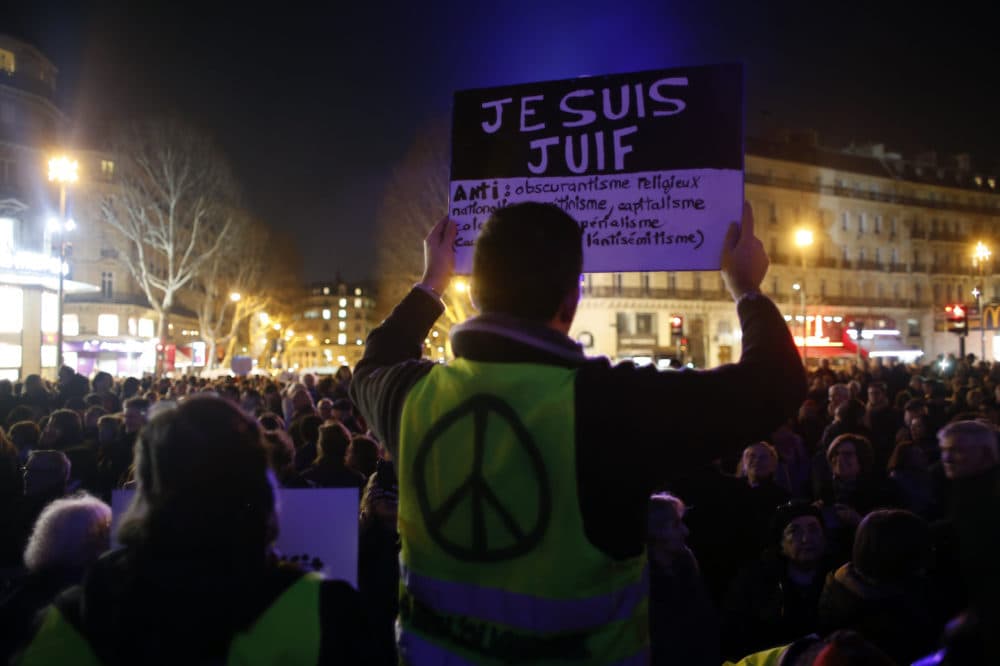A man wearing a yellow vest holds a placard reading &quot;I am jew&quot;, during a gathering at the Republique square to protest against anti-Semitism, in Paris, France, Tuesday, Feb. 19, 2019. (Thibault Camus/AP)