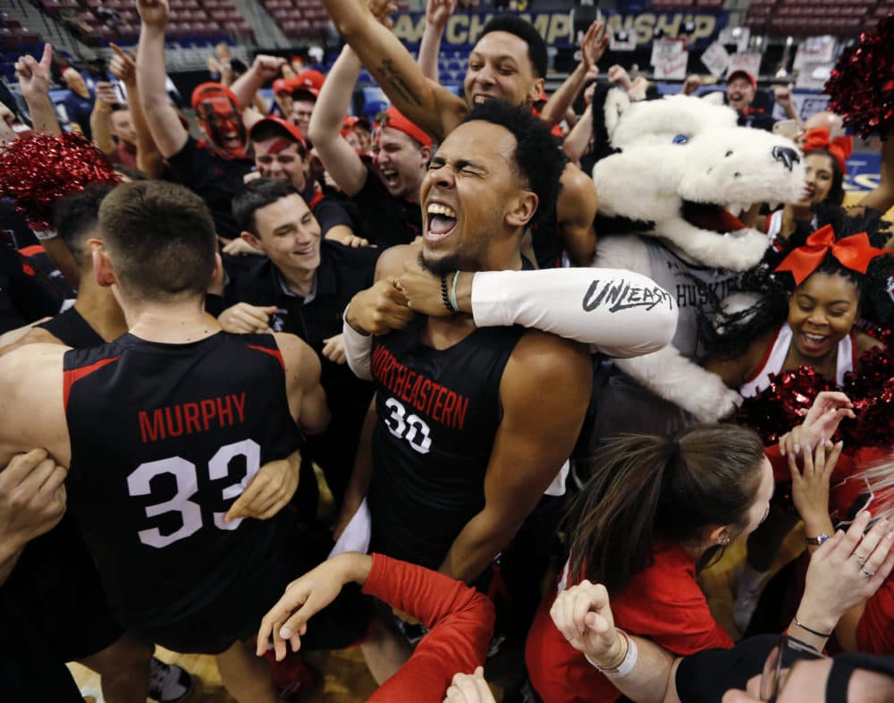 Northeastern's Anthony Green (30) celebrates with fellow players and fans after defeating Hofstra 82-74 in an NCAA college basketball game to win the Colonial Athletic Association men's basketball championship, Tuesday, March 12, 2019, in North Charleston, S.C. (AP Photo/Mic Smith)