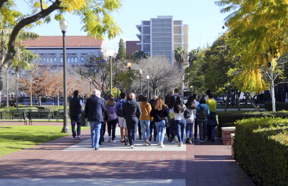 Prospective students and parents tour the University of Southern California campus. USC is one of many colleges moving swiftly to distance itself from the employees swept up in a nationwide college admissions scheme. (Reed Saxon/AP)