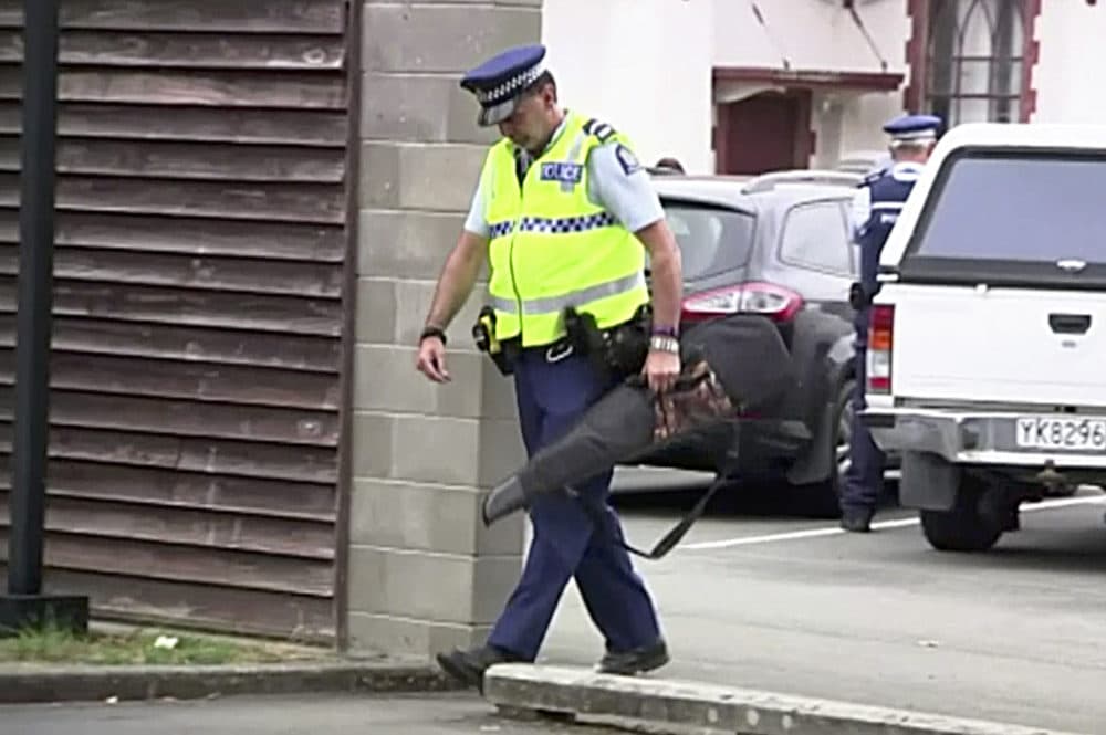 In this image made from video taken March 19, 2019, a police officer carries a gun voluntarily surrendered by a member of the public into the Masterton police station in Masterton, New Zealand. Prime Minister Jacinda Ardern says New Zealand is immediately banning sales of &quot;military-style&quot; semi-automatic and automatic weapons like the weapons used in last Friday's attacks on two Christchurch mosques. (TVNZ via AP)