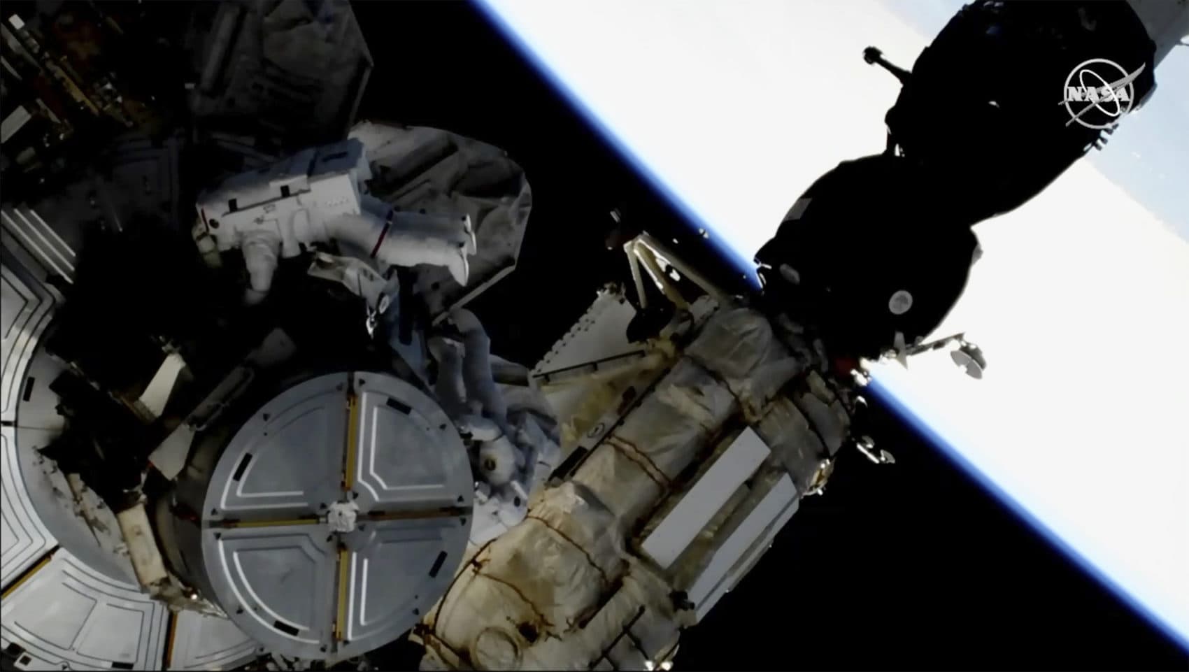 This image provided by NASA shows astronauts Anne McClain and Nick Hague taking a spacewalk to replace aging batteries on the International Space Station on Friday, March 22, 2019. (NASA via AP)