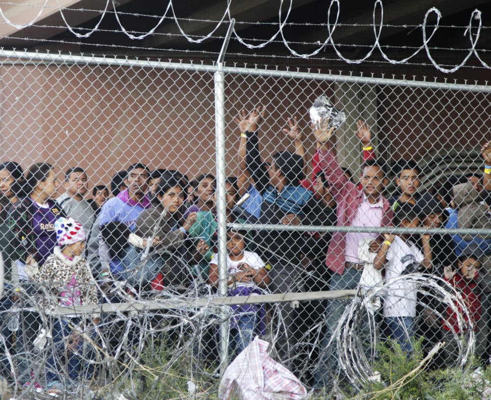Migrants wait for food in El Paso, Texas, on Wednesday, March 27, 2019, in a pen erected by U.S. Customs and Border Protection to process a surge of migrant families and unaccompanied minors. Earlier on Wednesday, Customs and Border Protection Commissioner Kevin McAleenan announced the the Trump administration will temporarily reassign several hundred border inspectors. (Cedar Attanasio/AP)