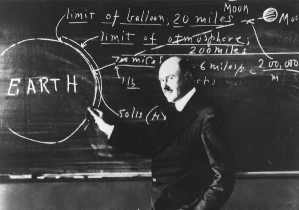 Dr. Robert H. Goddard at the blackboard at Clark University, Worcester, Mass., in 1924, explaining the method by which a rocket might reach the moon. (AP photo)
