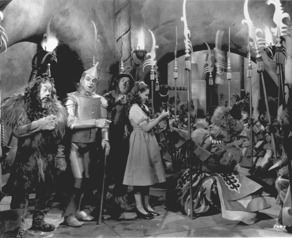 Judy Garland, as Dorothy in &quot;The Wizard of Oz,&quot; is presented with the Witch's broom in a scene from the 1939 movie. Garland is accompanied by, from left to right, Bert Lahr as the Cowardly Lion, Jack Haley as the Tin Man, and Ray Bolger as the Scarecrow. (AP Photo)