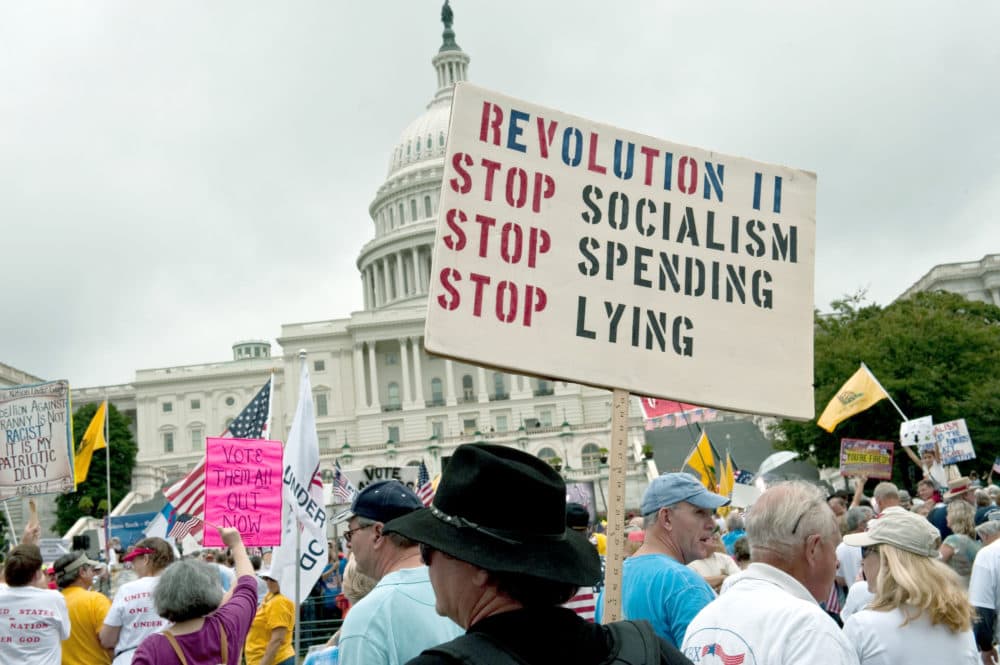 A demonstrator carries a sign calling for a second American revolution to bring an end to alleged socialism during a march by supporters of the conservative Tea Party movement in Washington, D.C., on September 12, 2010. (Nicholas Kamm/AFP/Getty Images)