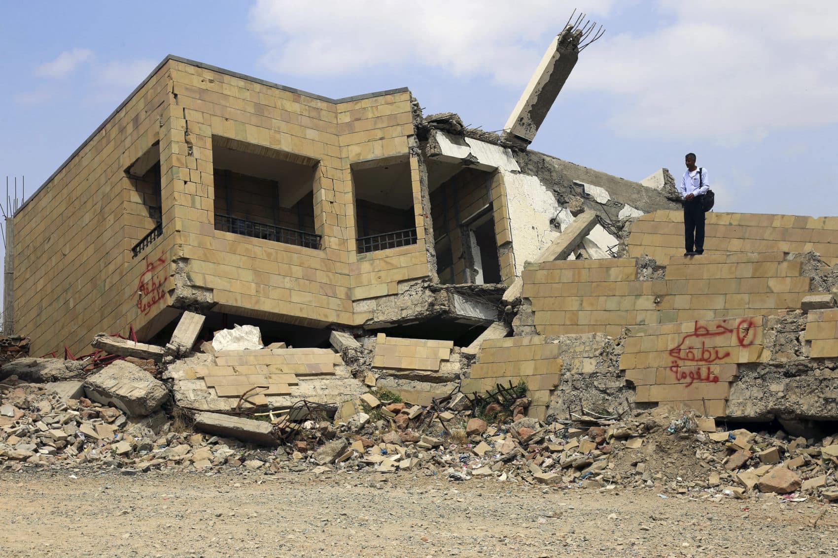 A Yemeni student stands on top of the debris of a school, that was damaged last year following a Saudi-led coalition air strike against Shiite Huthi, in the country's third-city of Taez, on March 6, 2019. (-/AFP/Getty Images)