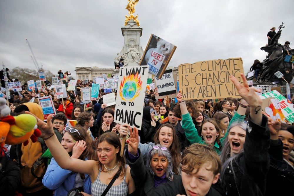 Young demonstrators in the U.K. hold placards as they protest around the Queen Victoria Memorial during the &quot;Global Strike 4 Climate&quot; protest march, outside of Buckingham Palace in central London on March 15, 2019. (Tolga Akmen/AFP/Getty Images)