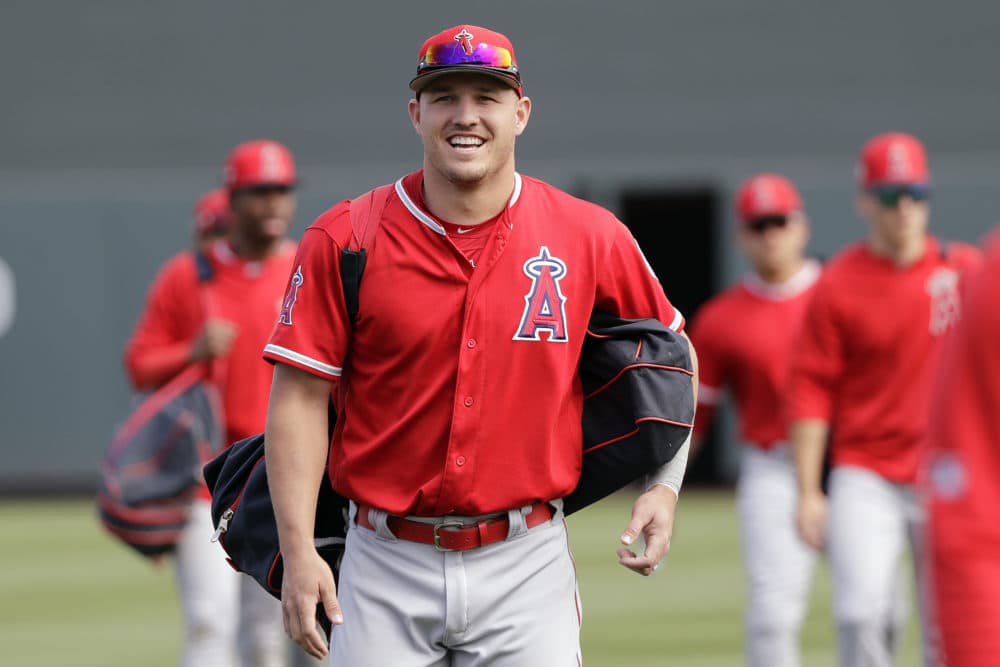 Los Angeles Angels' Mike Trout has 430 million reasons to smile as he walks onto the field before a spring training game this week. (Elaine Thompson/AP)
