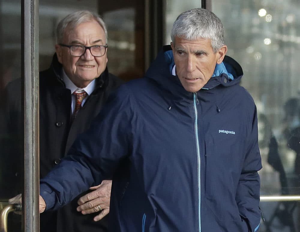 William &quot;Rick&quot; Singer, front, founder of the Edge College &amp; Career Network, exits federal court in Boston on Tuesday, March 12, 2019, after he pleaded guilty to charges in a nationwide college admissions bribery scandal. (Steven Senne/AP)