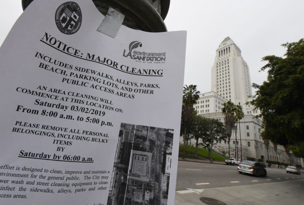 A notice alerting the public and homeless who stay nearby that the area around the Los Angeles City Hall will undergo a major cleaning to combat a rat infestation inside the building is posted nearby in Los Angeles on March 1, 2019. (Mark Ralston/AFP/Getty Images)