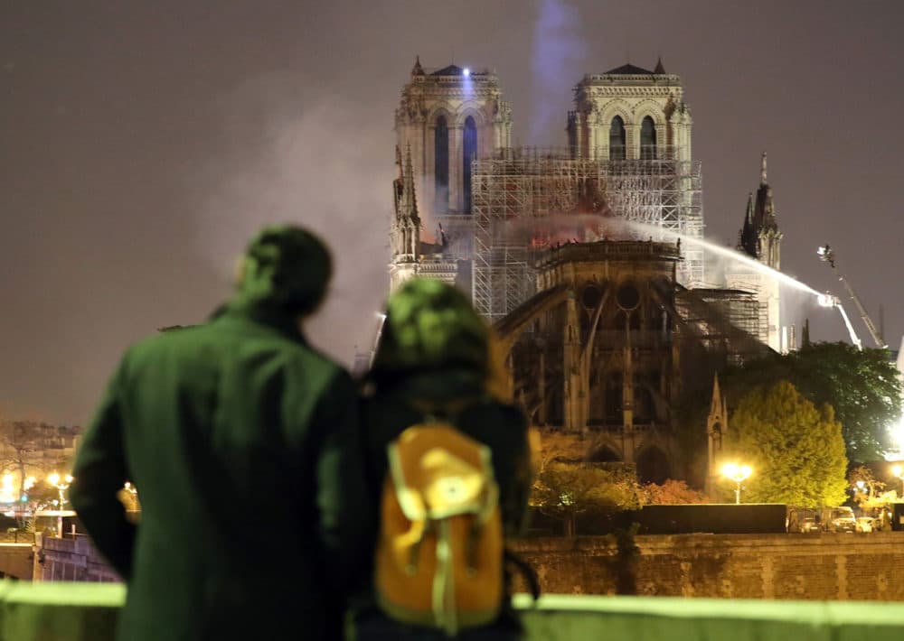 Residents look as firefighters battle to extinguish a giant fire that engulfed the Notre Dame Cathedral in Paris. (Courtesy of Maya Vidon-White)