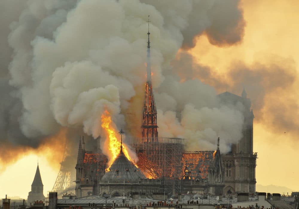 Flames and smoke rise from the blaze at Notre Dame cathedral in Paris on Monday, April 15. (Thierry Mallet/AP)