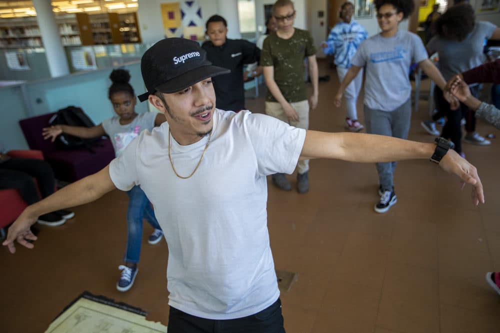 Floor Lords Crew dancer Alex Diaz shows students a few moves during &quot;The Breaks&quot; at Grove Hall Library. (Jesse Costa/WBUR)