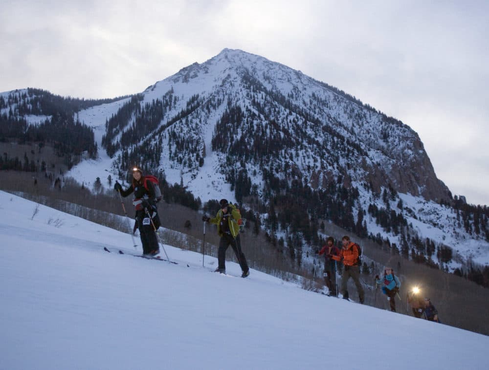 Mountaineering skiers crosses the base of Crested Butte Mountain, Colorado, at 6:30 a.m. on their way to Aspen, Colorado. (Nathan Bilow/AP)