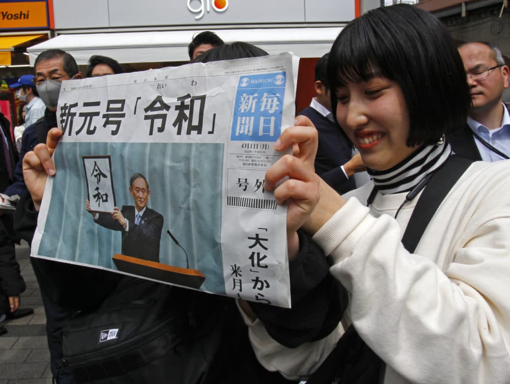 A woman holds a copy of the Mainichi Shimbun newspaper reporting the name of new era “Reiwa,&quot; unveiled in Tokyo, Monday, April 1, 2019. (Koji Sasahara/AP)