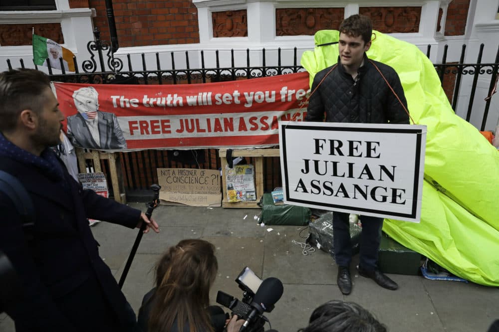 A protester holds a placard outside the Ecuadorian Embassy in London, after WikiLeaks founder Julian Assange was arrested by officers from the Metropolitan Police and taken into custody Thursday April 11, 2019. (Matt Dunham/AP)