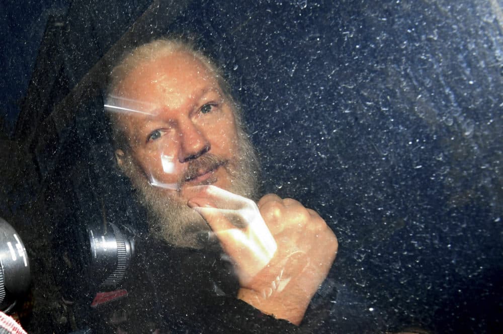 Julian Assange gestures as he arrives at Westminster Magistrates' Court in London, after the WikiLeaks founder was arrested by officers from the Metropolitan Police and taken into custody Thursday April 11, 2019. (Victoria Jones/PA via AP)