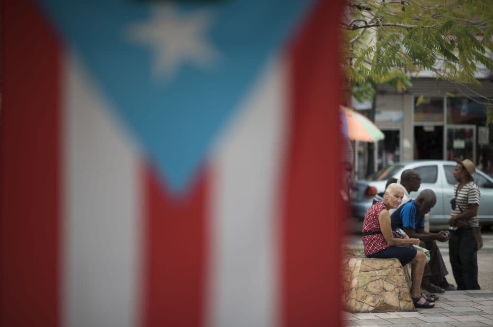 Residents sit outside the Plaza del Mercado in the Rio Piedras area of San Juan, Puerto Rico, Wednesday, April 17, 2019. (Carlos Giusti/AP)