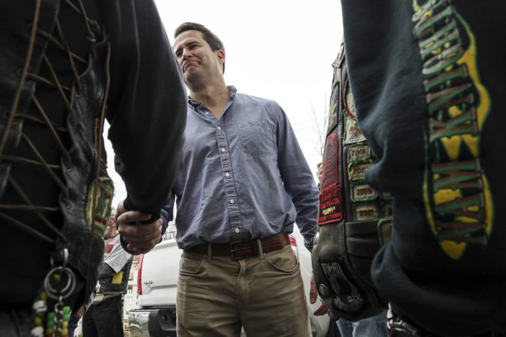 Rep. Seth Moulton, D-Mass., shakes hands with veterans at a campaign event held at Liberty House in Manchester, N.H., in April. (Cheryl Senter/AP)