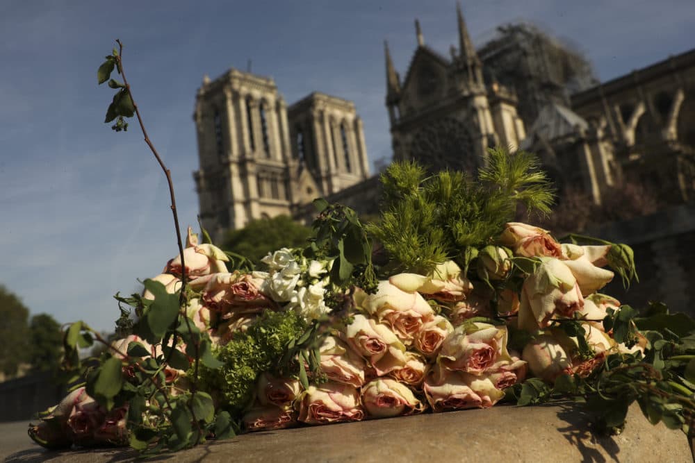 A bunch of flowers lies by the Seine riverside near the Notre Dame cathedral in Paris, Thursday, April 18, 2019. (Francisco Seco/AP)