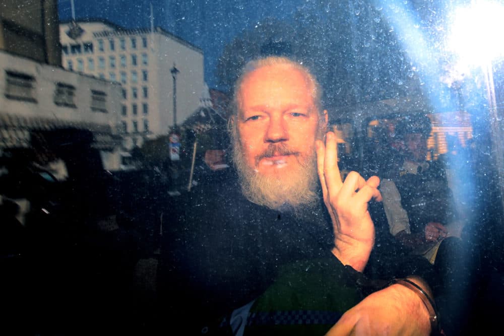 Julian Assange gestures to the media from a police vehicle on his arrival at Westminster Magistrates court on April 11, 2019 in London, England. (Jack Taylor/Getty Images)