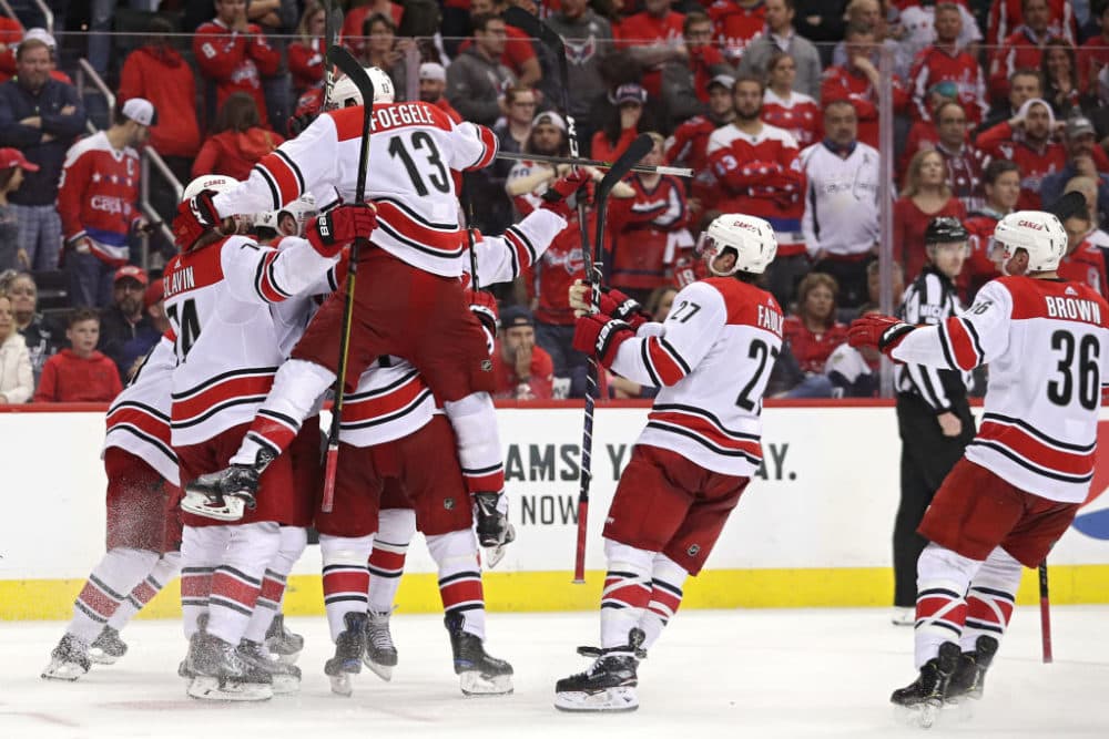 The Carolina Hurricanes celebrate the series-winning goal against the Washington Capitals, the 2018 Stanley Cup champions. (Patrick Smith/Getty Images)