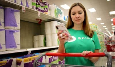 Shipt shopper Blakely Segroves shops for a member at a Super Target in Hoover, Ala. The app lets users make a shopping list, and shoppers like Segroves then buy the user's items and deliver them to their home. Founded in Birmingham, Ala., Shipt is helping drive a tech boom in the region. (Ciku Theuri/Here & Now)