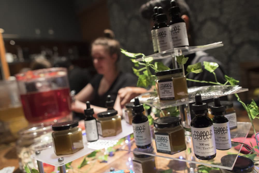 Samples of THC laced products are on display as a bartender prepares drinks at the Spleef NYC canna-cocktail party in New York. (Mary Altaffer/AP)