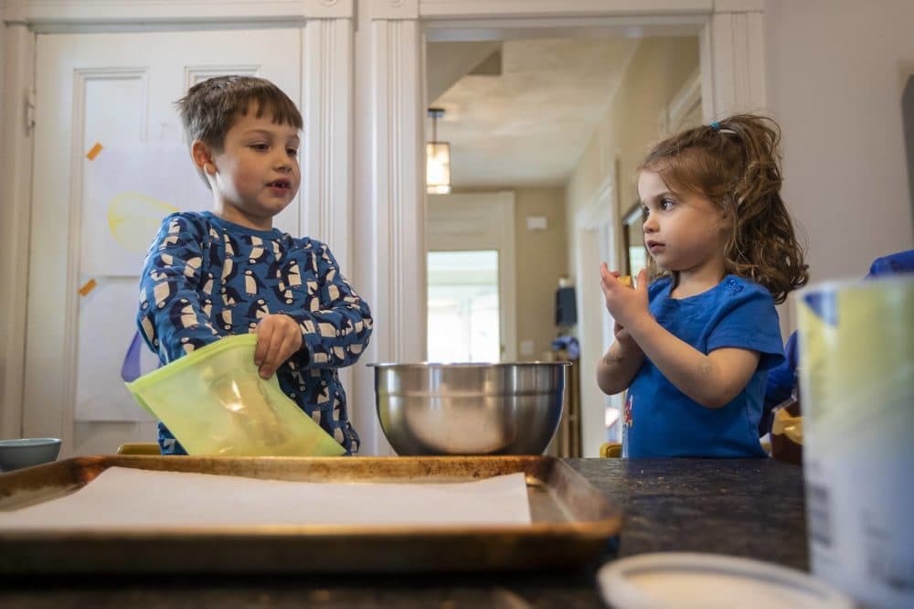 Ben and Margaret help with dinner by breading the tofu dippers. (Jesse Costa/WBUR)