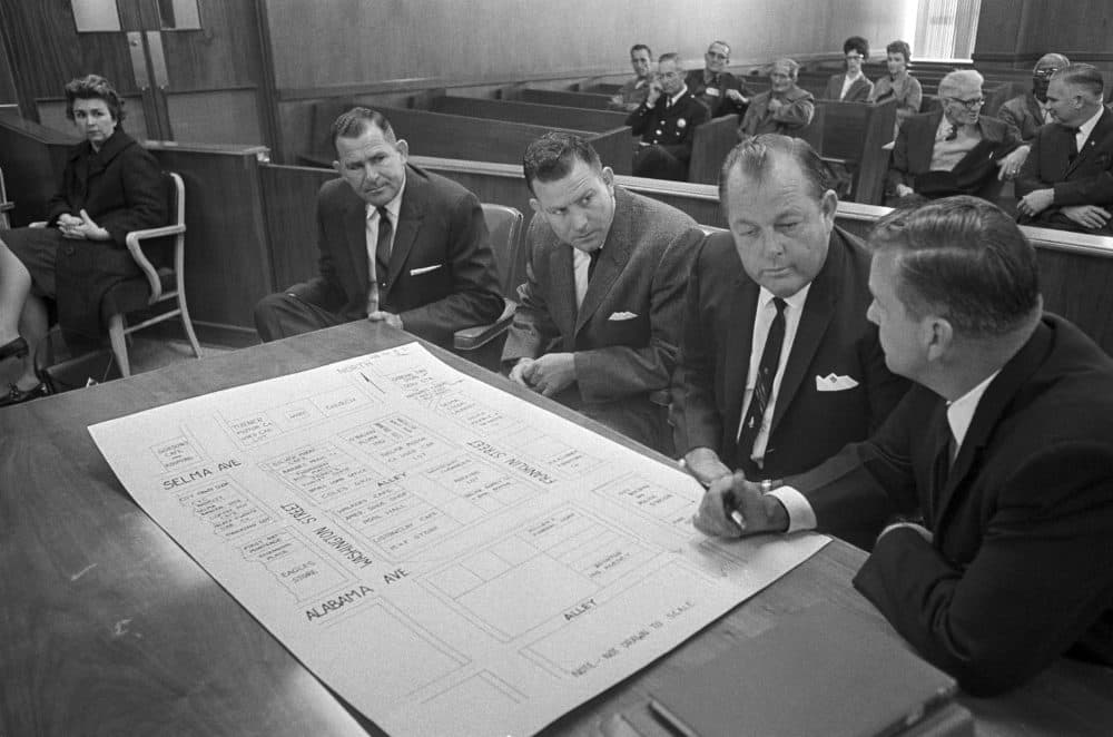 In this 1965 file photo, three defendants go over a street diagram of an area in Selma, Ala., where the clubbing death of a Unitarian Universalist minister, Rev. James Reeb, took place. (Horace Cort/AP)