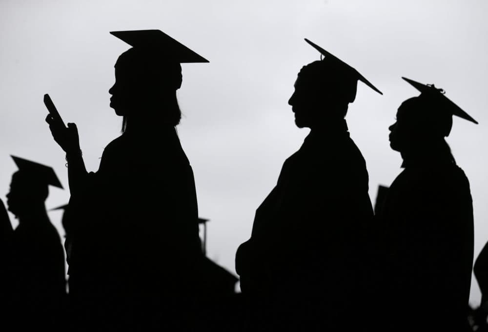 College graduates about to receive their diploma. (Seth Wenig/AP)
