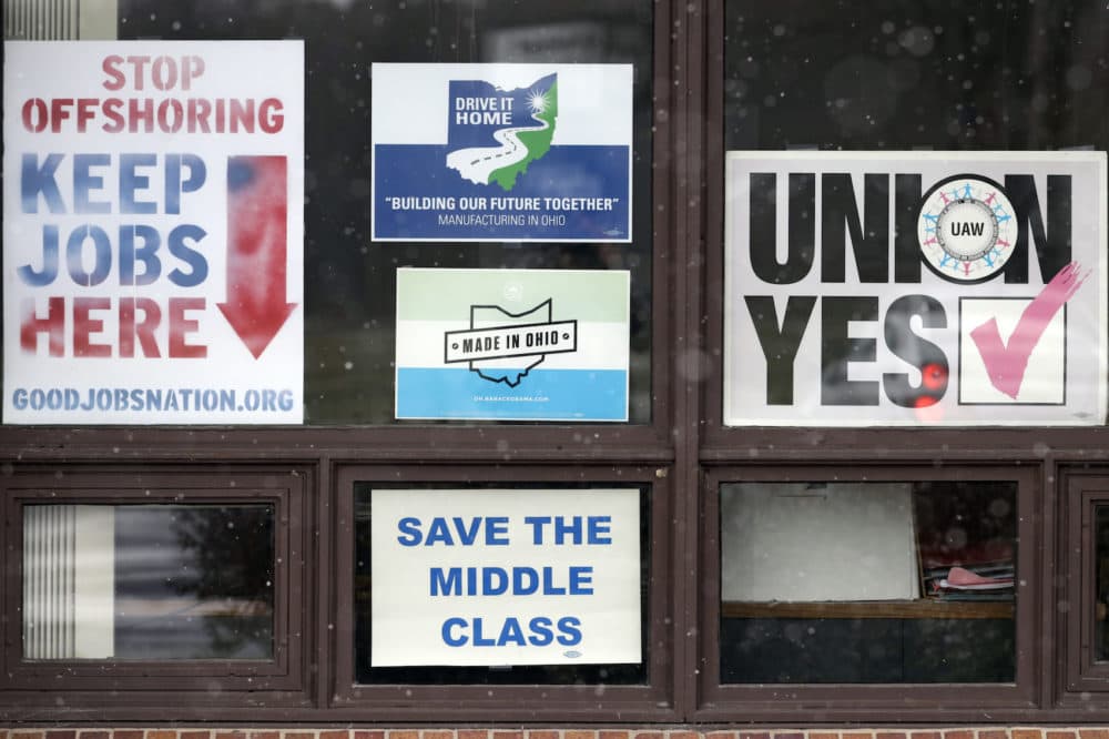 In this Nov. 27, 2018 photo, signs hang from windows at the UAW Local 1112 union hall, in Lordstown, Ohio. (Tony Dejak/AP)