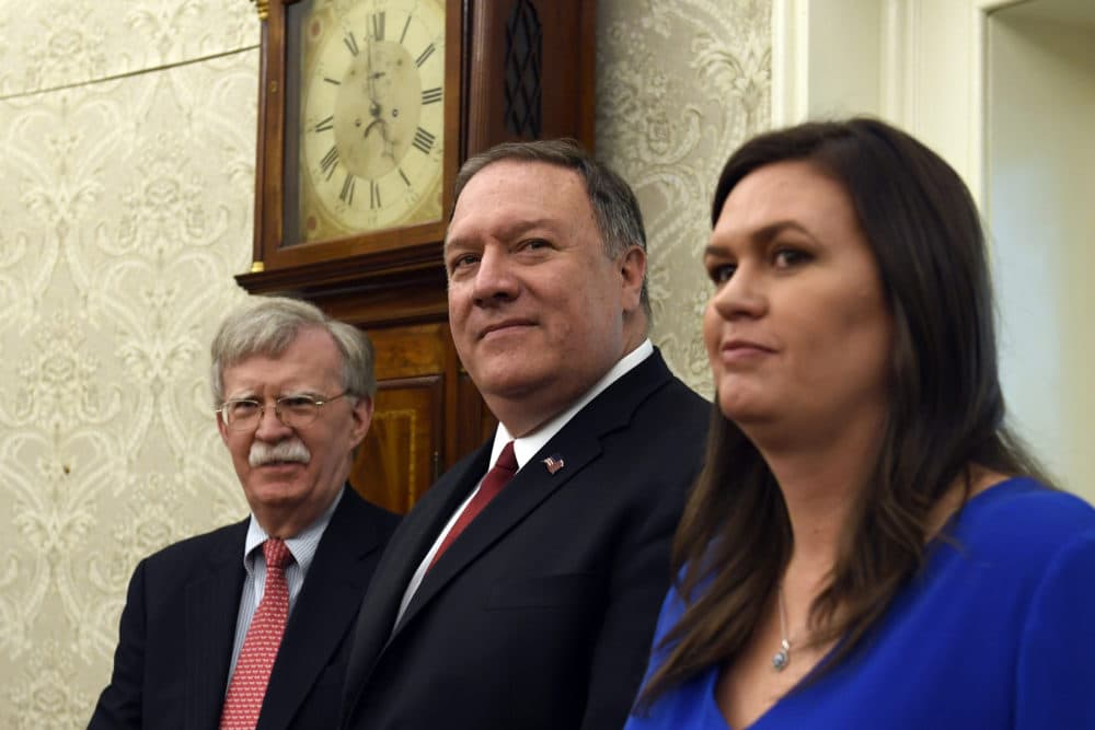 Secretary of State Mike Pompeo, center, flanked by national security adviser John Bolton, left, and White House press secretary Sarah Sanders, right, listen during the meeting between President Donald Trump and Japanese Prime Minister Shinzo Abe in the Oval Office of the White House in Washington, Friday, April 26, 2019. (Susan Walsh/AP)