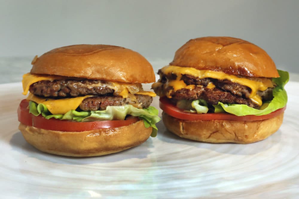 An Original Impossible Burger, left, and a Cali Burger, from Umami Burger, are shown in this photo in New York, Friday, May 3, 2019. (Richard Drew/AP)