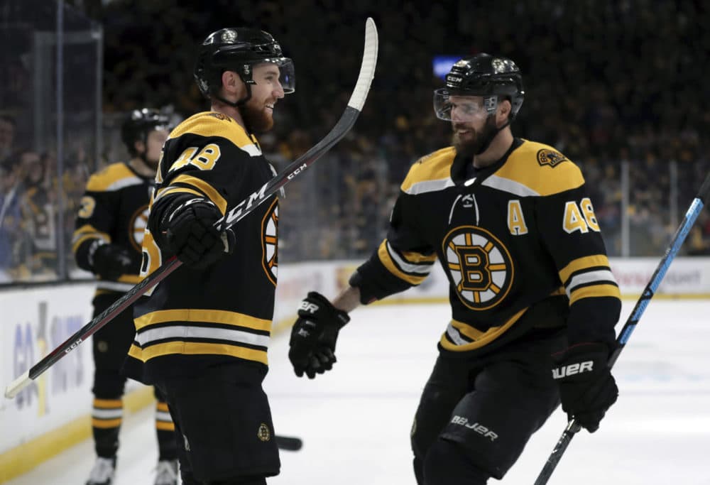 Boston Bruins' Matt Grzelcyk, left, celebrates his goal against the Carolina Hurricanes with David Krejci during the second period in Game 2 of the NHL hockey Stanley Cup Eastern Conference final series, Sunday, May 12, 2019, in Boston. (Charles Krupa/AP)