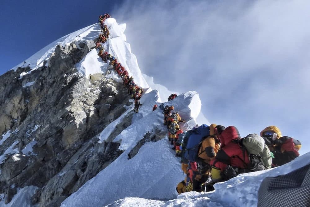In this photo made on May 22, 2019, a long queue of mountain climbers line a path on Mount Everest. (Nirmal Purja/@Nimsdai Project Possible via AP)